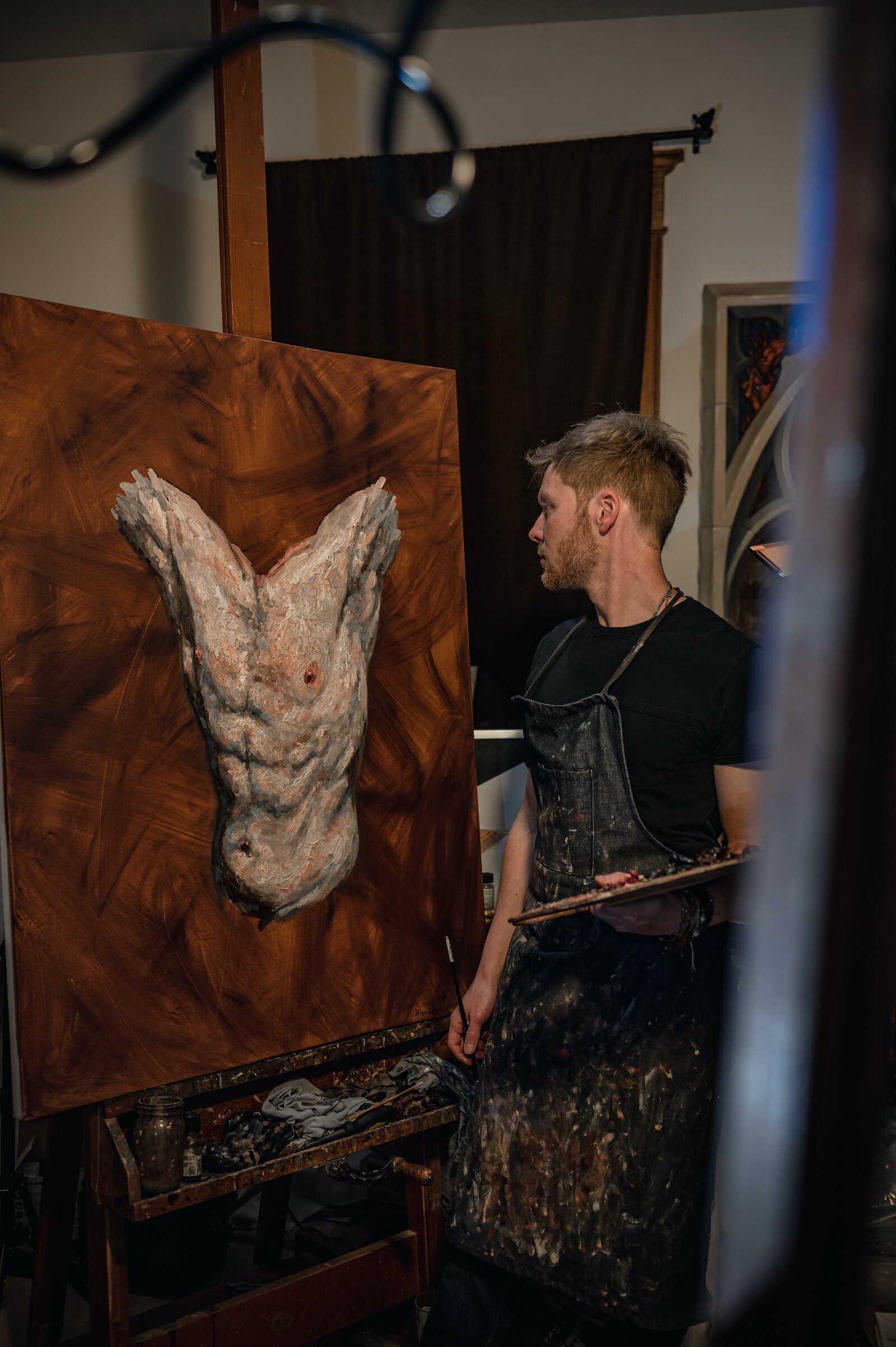 Artist Peter Lupkin works on a painting in studio.
