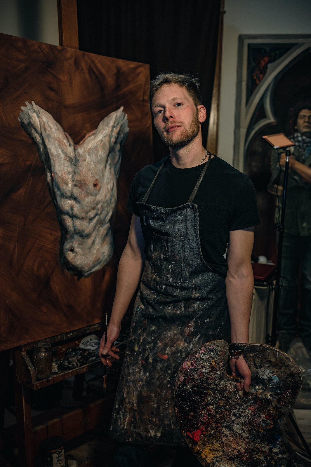 Artist Peter Lupkin works on a painting in studio.