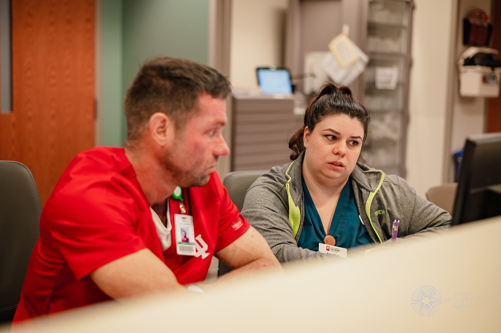 A student from Indiana University's School of Nursing Fort Wayne asks Parkview Nurse and Instructor Roni Elliott questions about electronic health records.