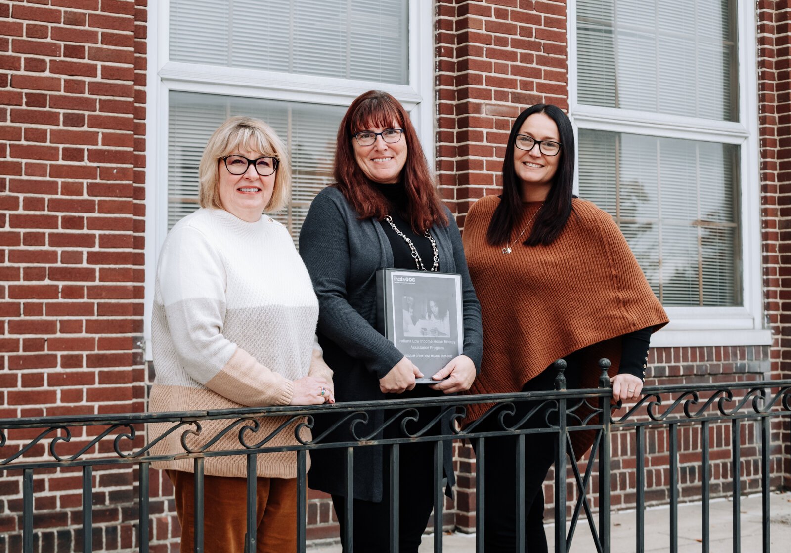 Brightpoint VP of Community Services, Pam Brookshire, left, and Family Support Services Manager, Lesa Cassel, center, with Dana Berkes, right, Public Affairs & Economic Development Manager at NIPSCO in front of Brightpoint at 227 E. Washington Blvd.
