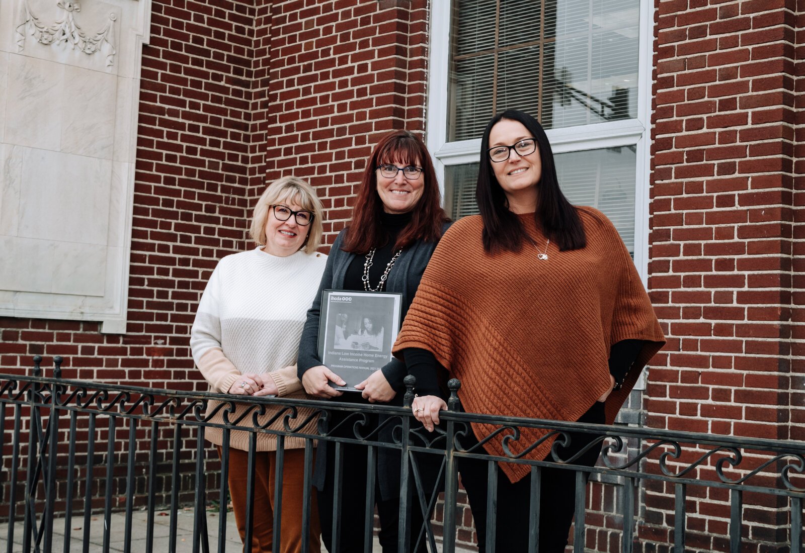 Brightpoint VP of Community Services, Pam Brookshire, left, and Family Support Services Manager, Lesa Cassel, center, with Dana Berkes, right, Public Affairs & Economic Development Manager at NIPSCO in front of Brightpoint at 227 E. Washington Blvd.