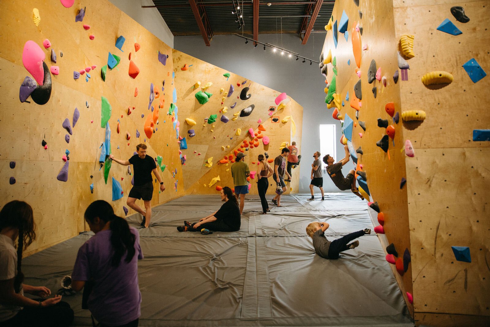 Founding members attempt routes at the soft opening of Summit City Climbing Co.