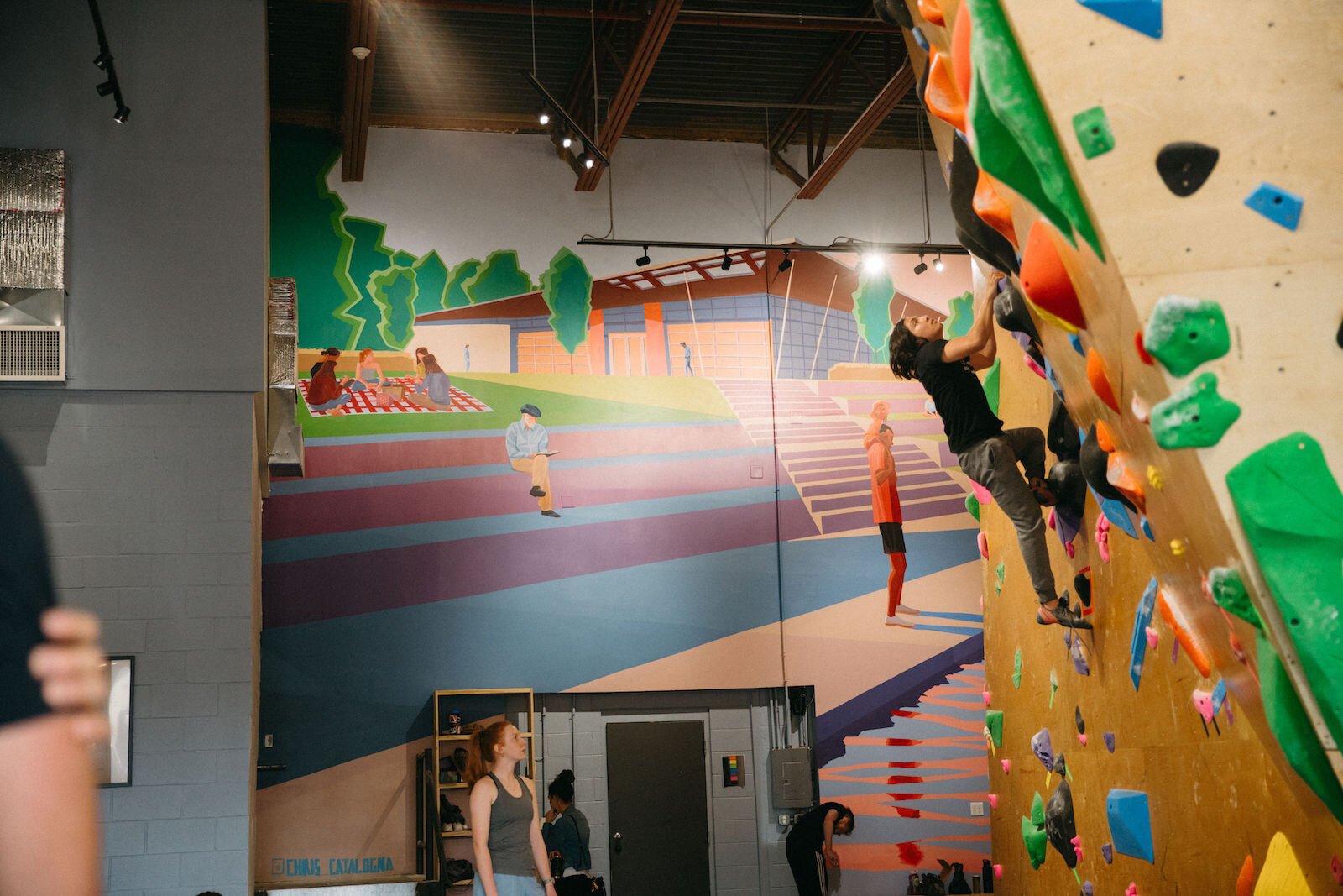 Climbers explore bouldering routes.