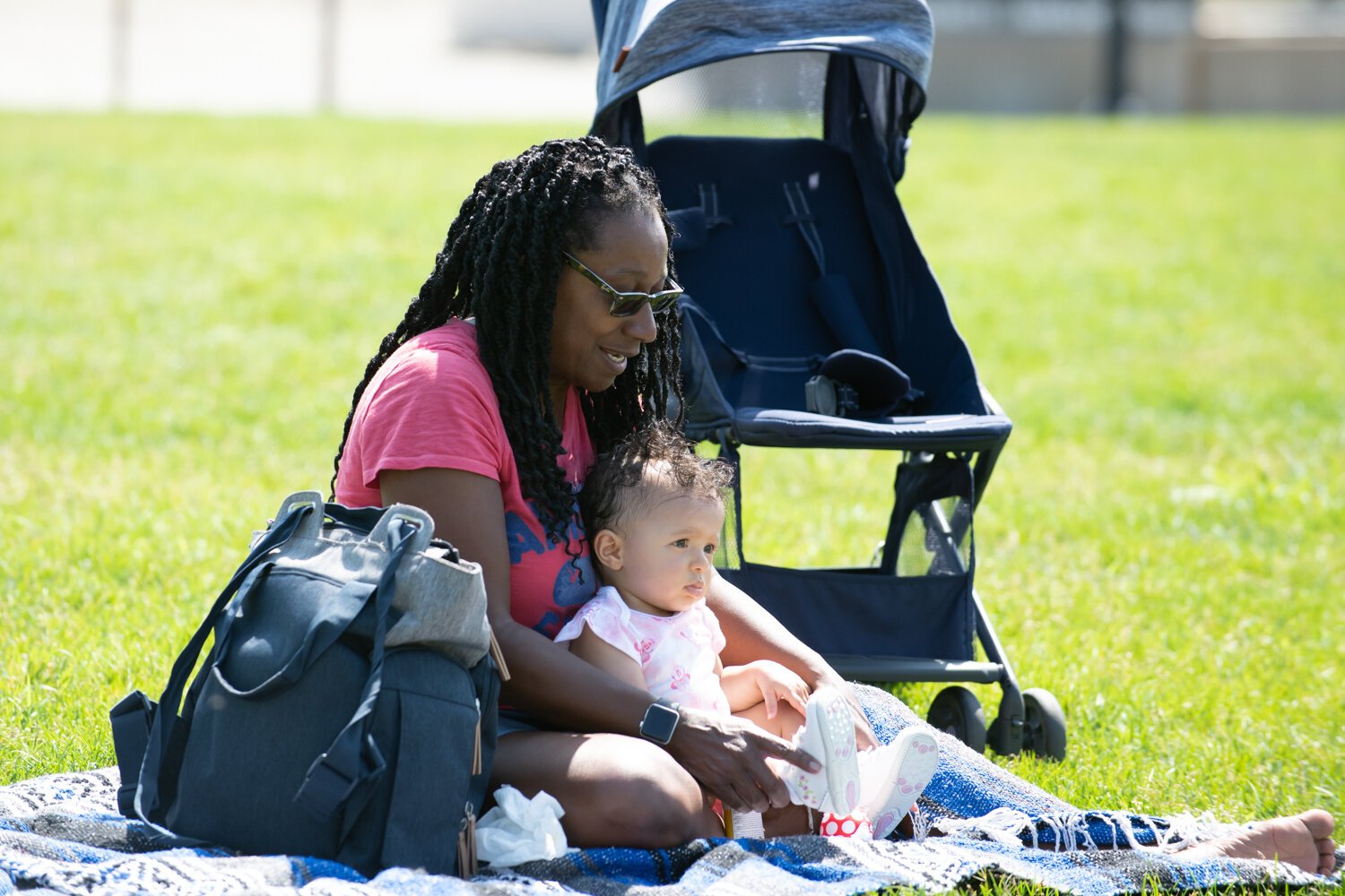 Christel Hayes and her 10-month-old granddaughter, Maia, enjoy Storytime at the Park in June.