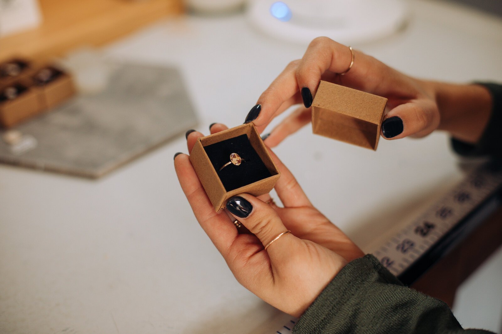 Owner Raelyn Bever holds a finished ring from Still Remains Jewelry.