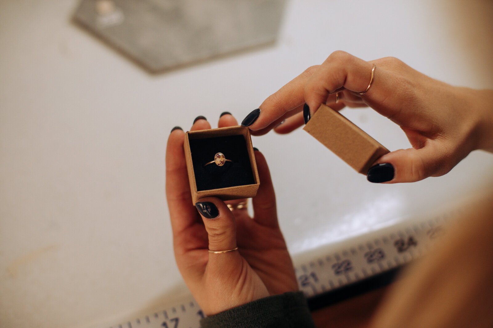 Owner Raelyn Bever holds a finished ring from Still Remains Jewelry.