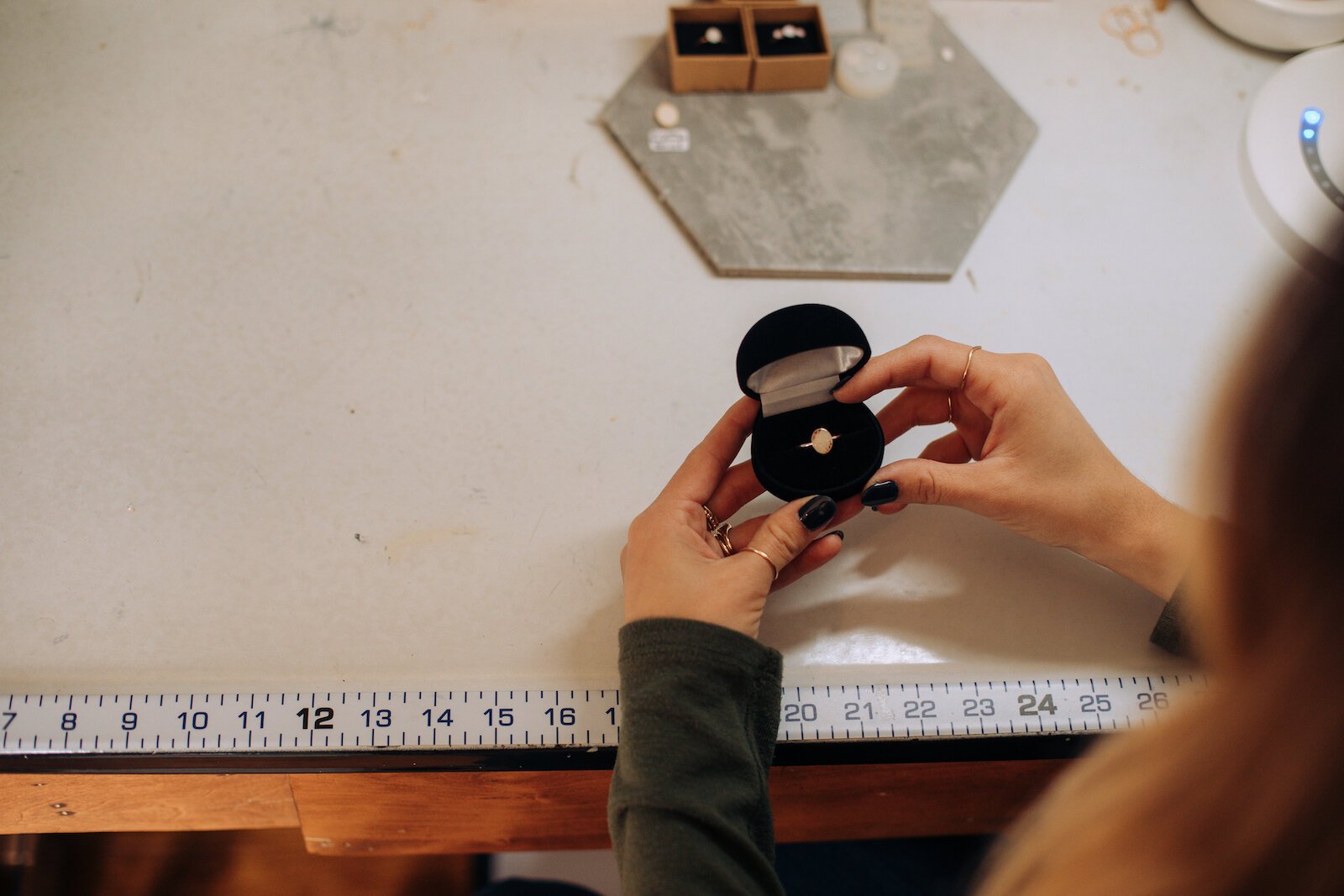 Owner Raelyn Bever holds a finished ring from Still Remains Jewelry.