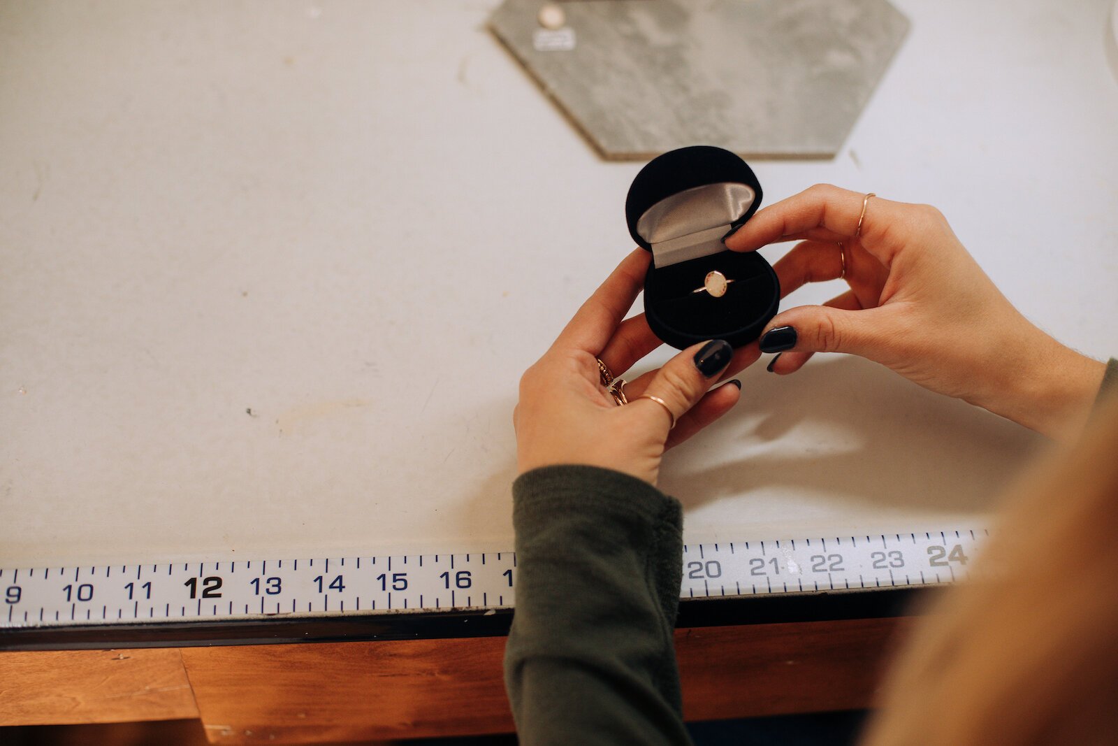 Owner Raelyn Bever holds a finished ring from Still Remains Jewelry.