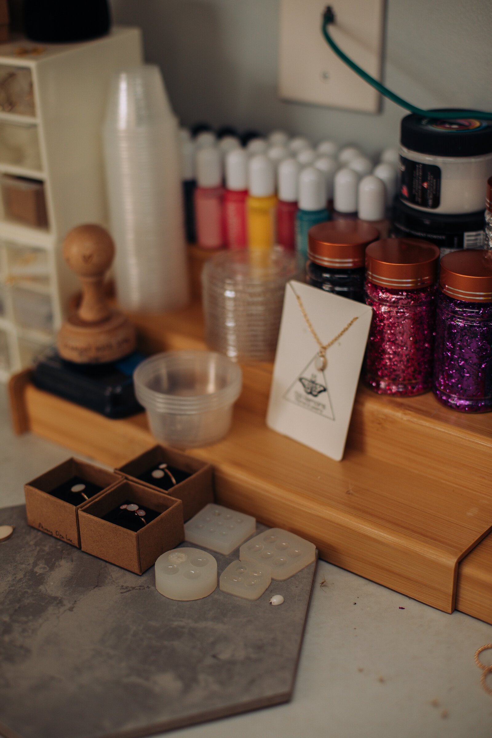 Materials and completed jewelry displayed on Raelyn Bever's desk.