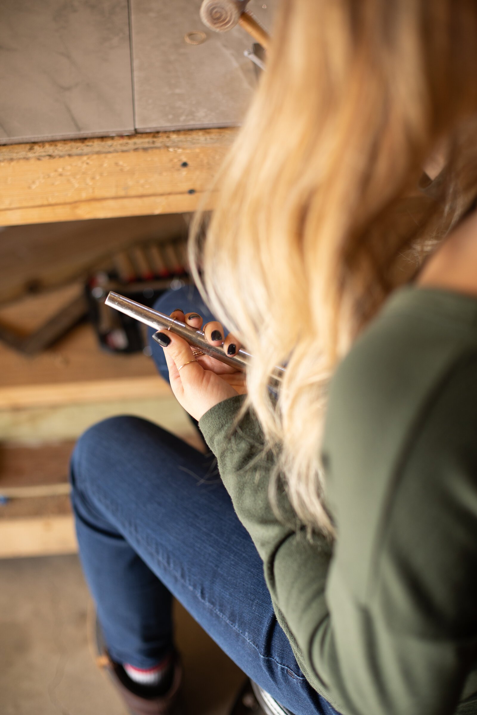 Still Remains Owner Raelyn Bever works on a ring in her garage workspace.