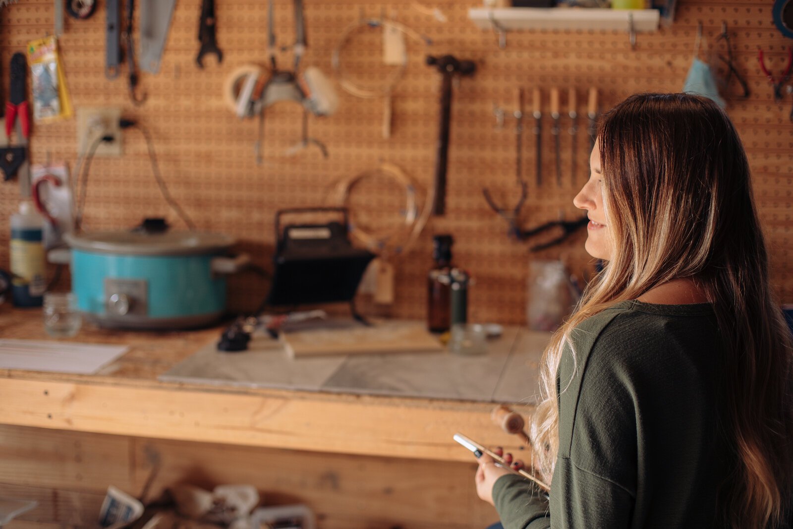 Still Remains Owner Raelyn Bever works on a ring in her garage workspace.