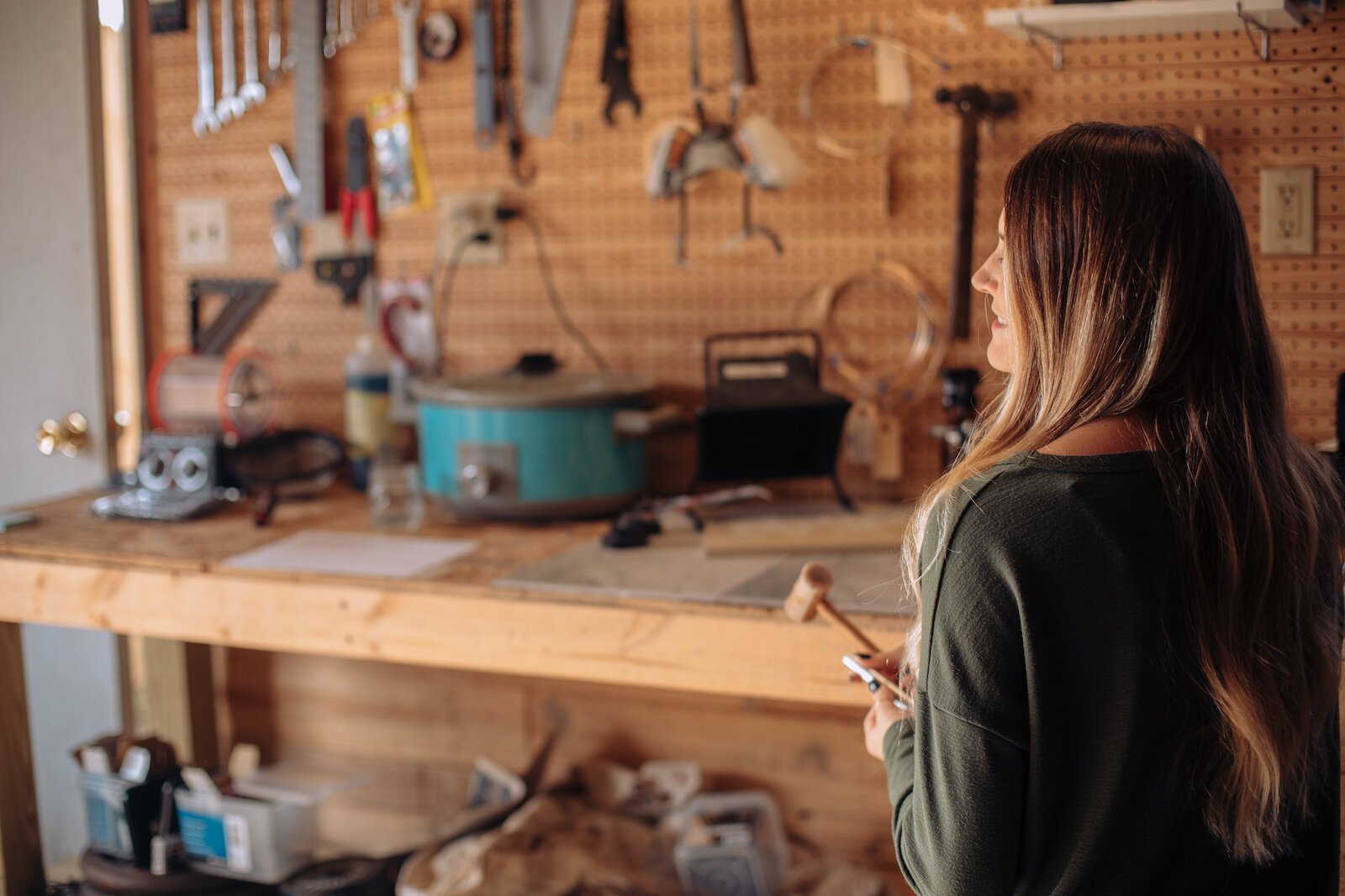 Still Remains Owner Raelyn Bever works on a ring in her garage workspace.