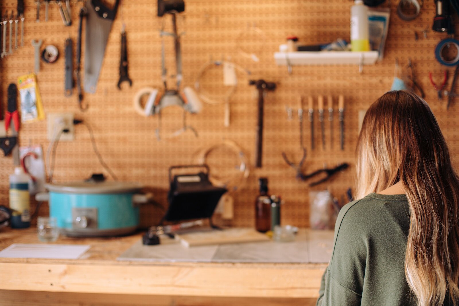 Still Remains Owner Raelyn Bever works on a ring in her garage workspace.