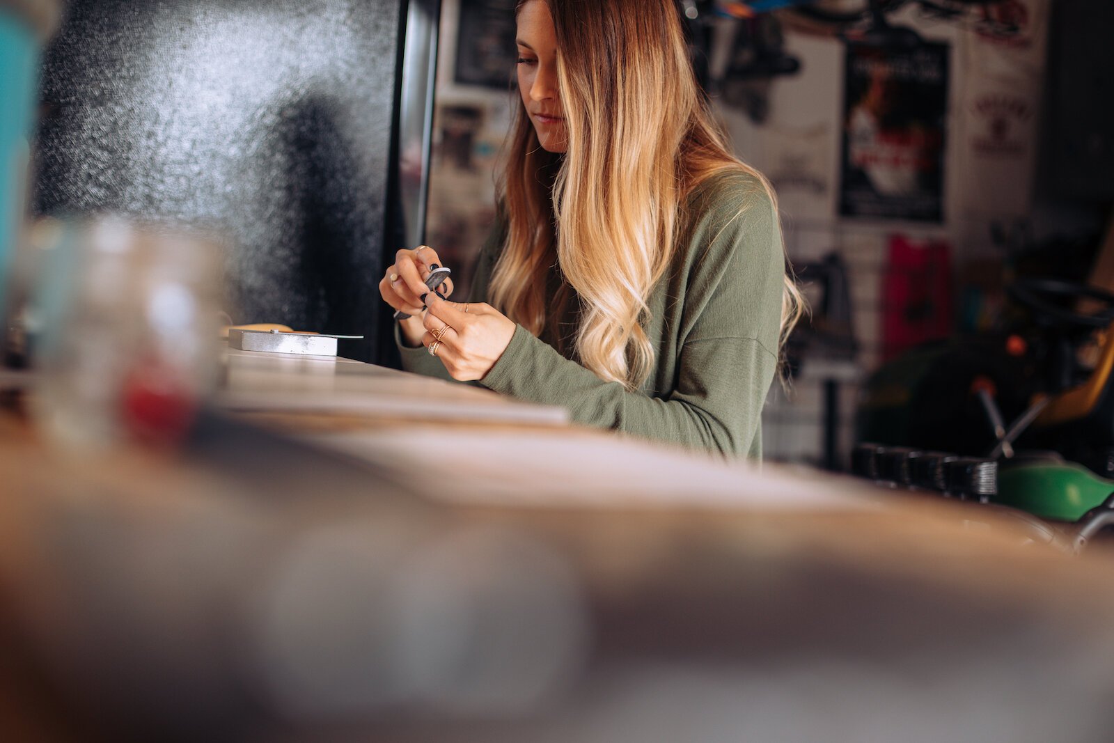 Still Remains Owner Raelyn Bever works on a ring in her garage workspace.