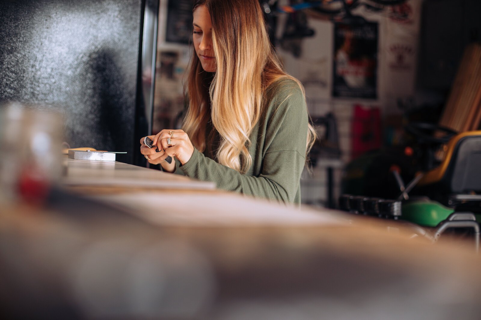 Still Remains Owner Raelyn Bever works on a ring in her garage workspace.