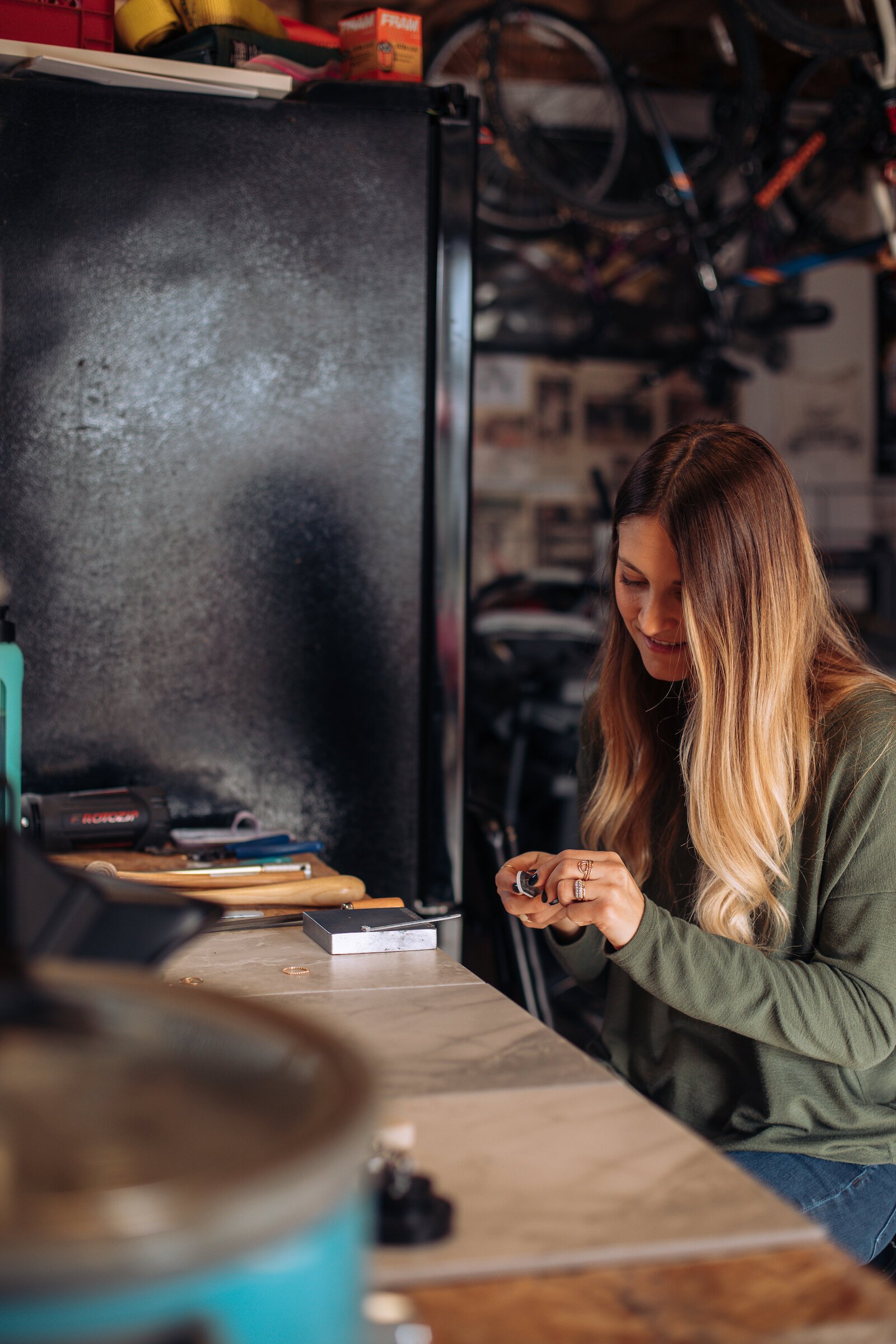 Still Remains Owner Raelyn Bever works on a ring in her garage workspace.