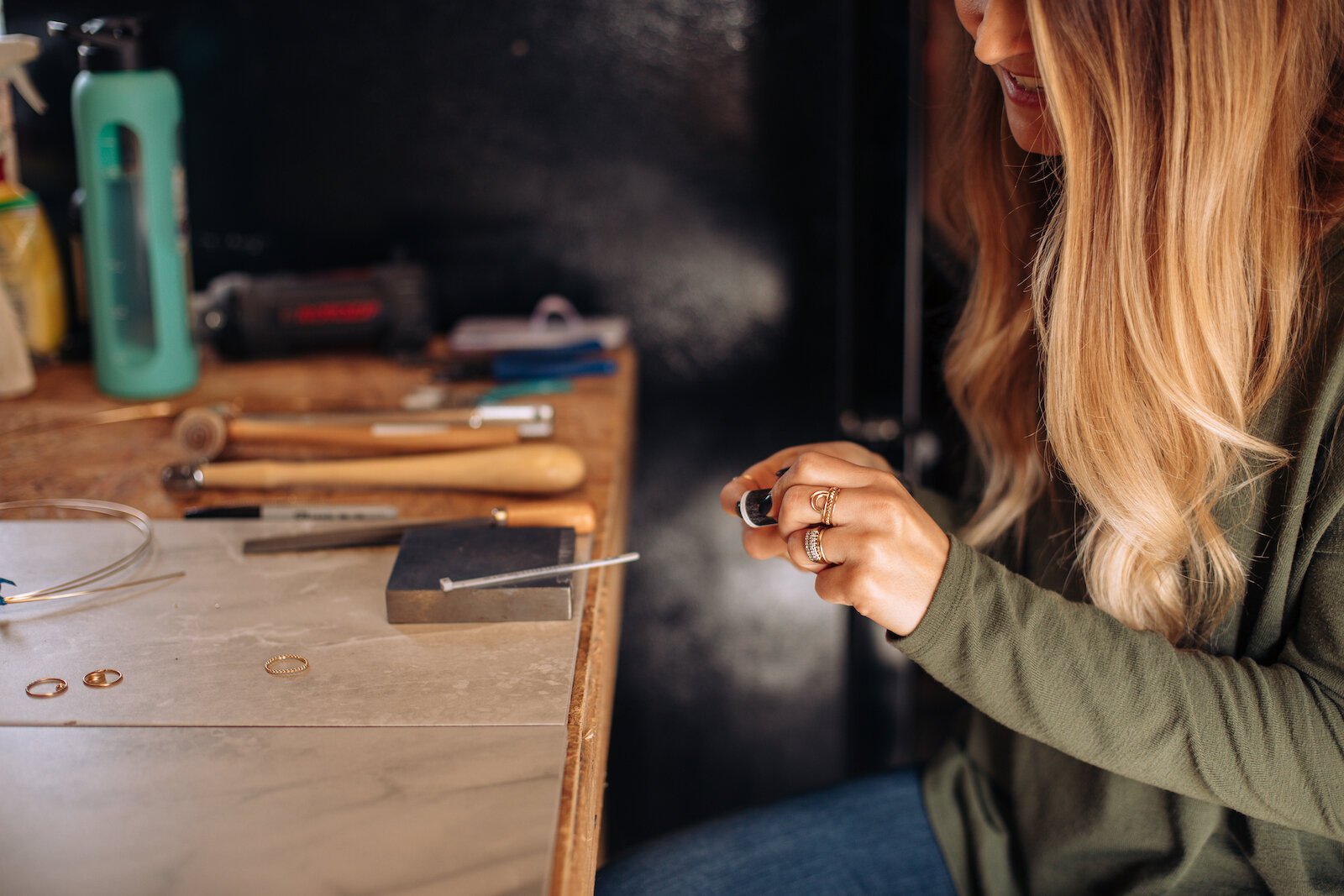 Still Remains Owner Raelyn Bever works on a ring in her garage workspace.