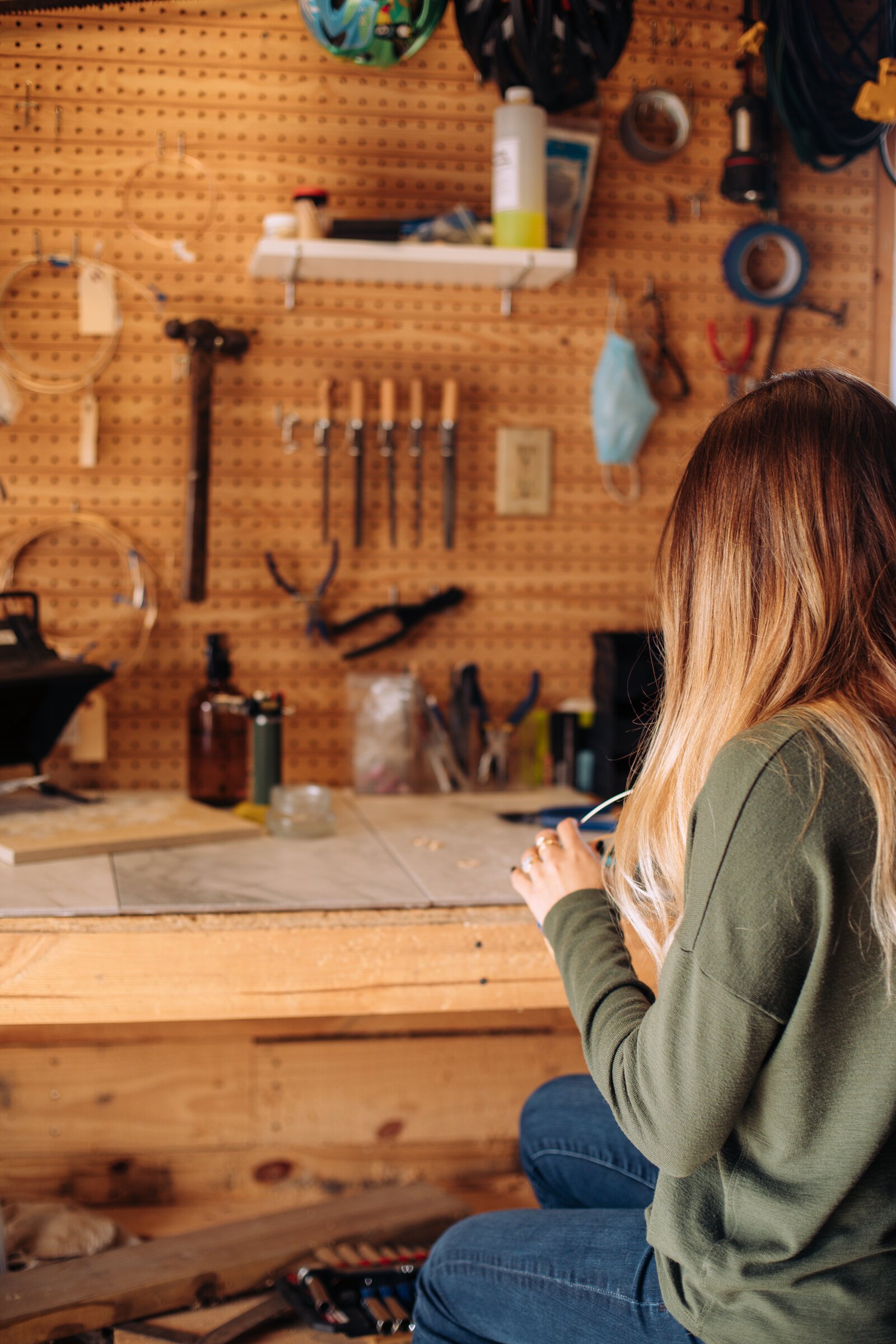 Still Remains Owner Raelyn Bever works on a ring in her garage workspace.