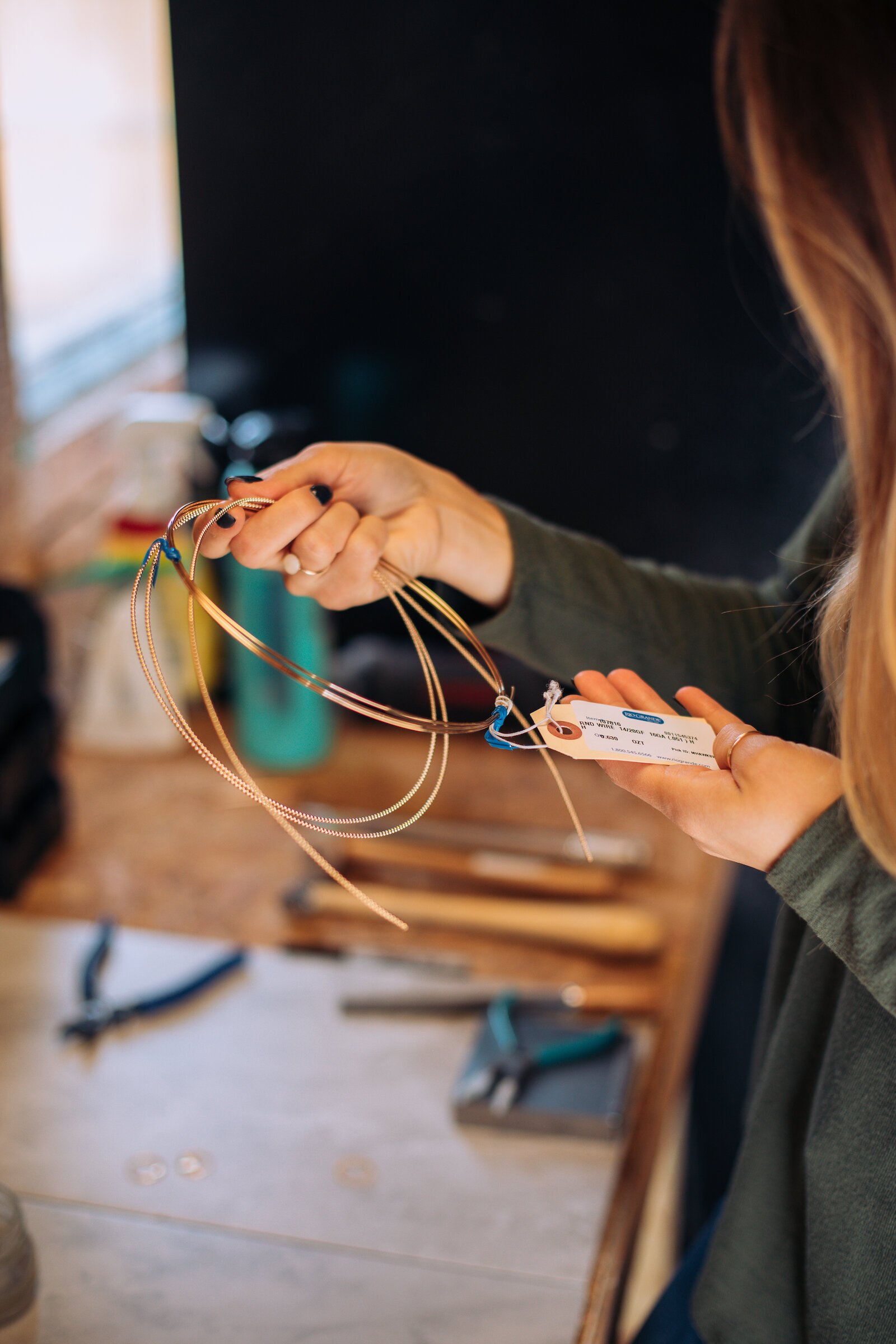 Still Remains Owner Raelyn Bever works on a ring in her garage workspace.