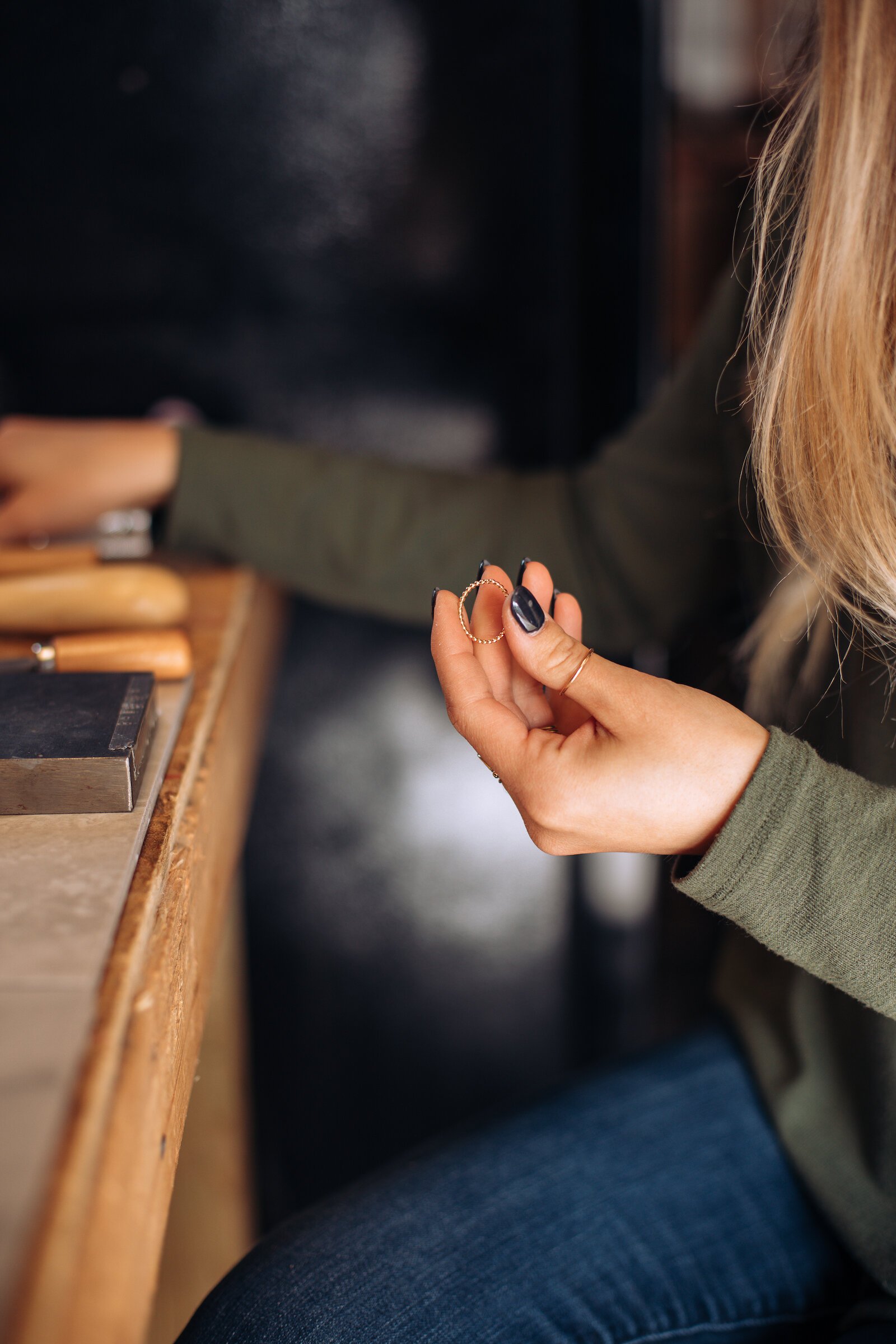 Still Remains Owner Raelyn Bever works on a ring in her garage workspace.