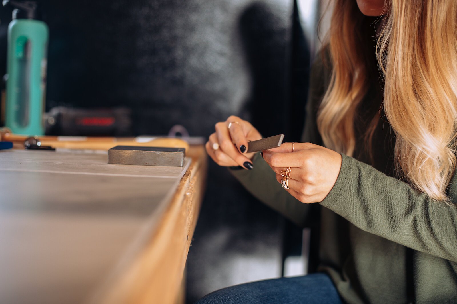 Still Remains Owner Raelyn Bever works on a ring in her garage workspace.