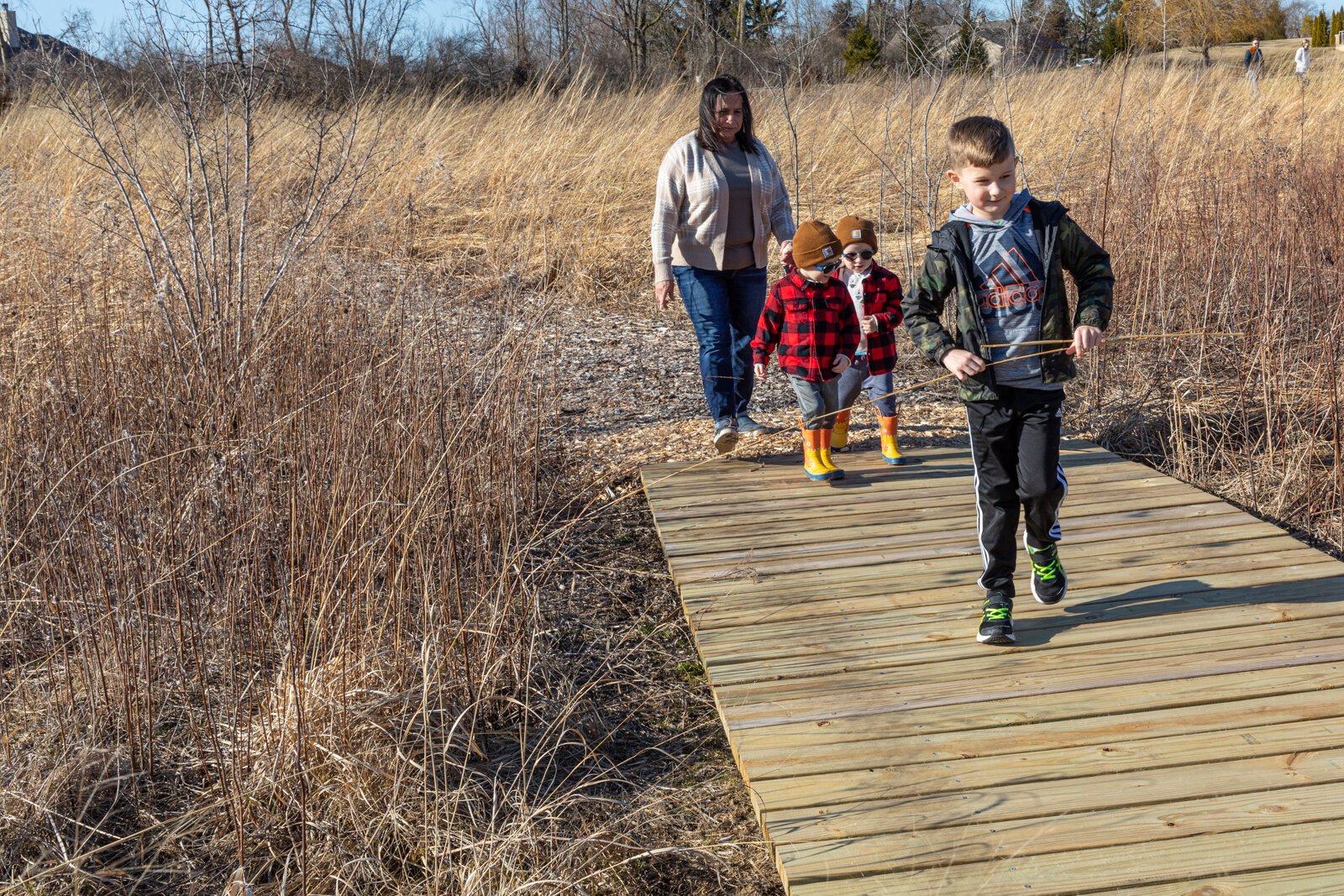 Families explore the prairie outside of Stillwater Hospice. 