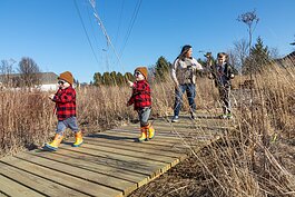 Families explore the prairie outside of Stillwater Hospice. 