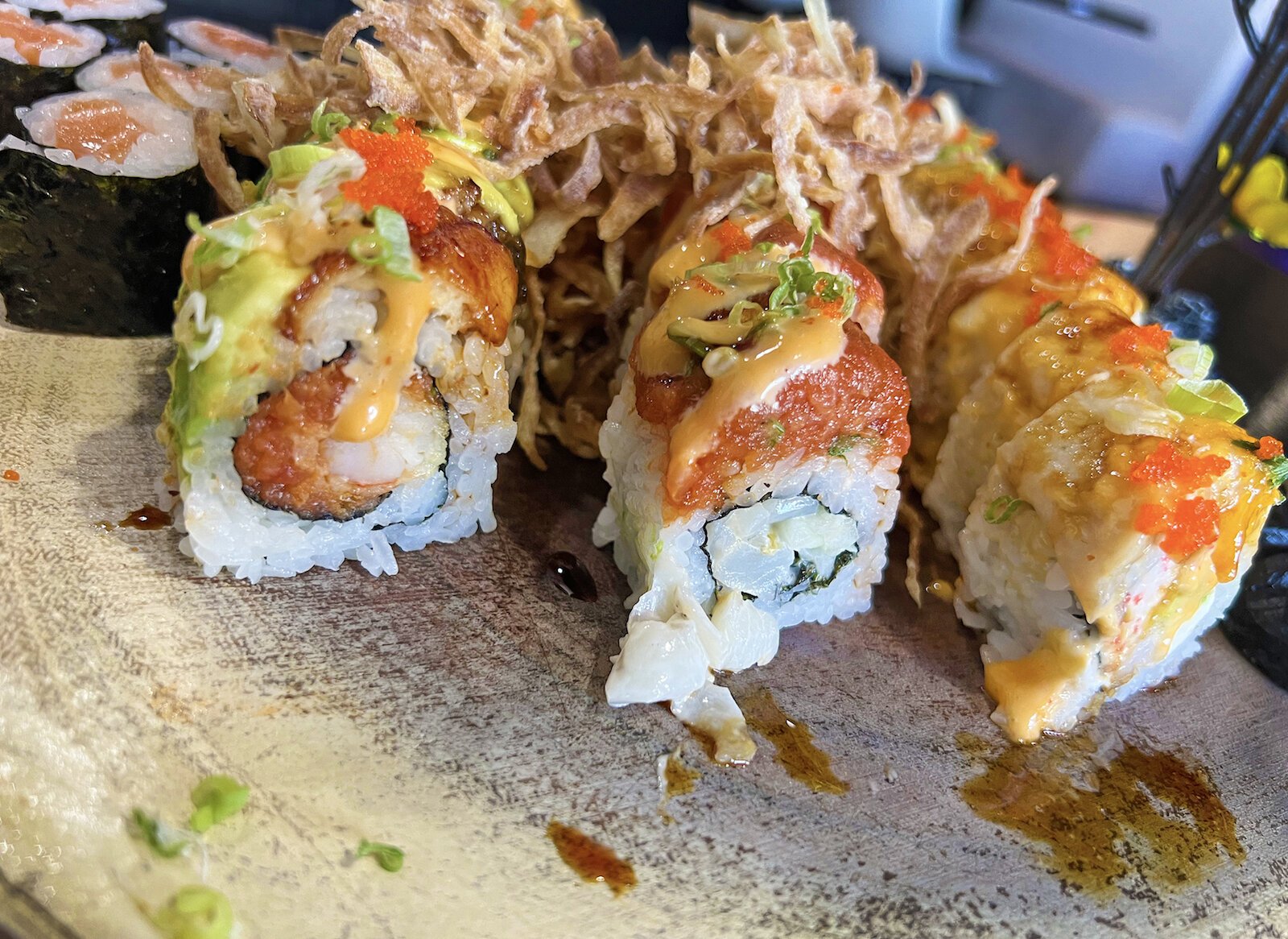 I order three of some of their most popular rolls, from left to right, the playboy, the scallop lover, and the samurai.