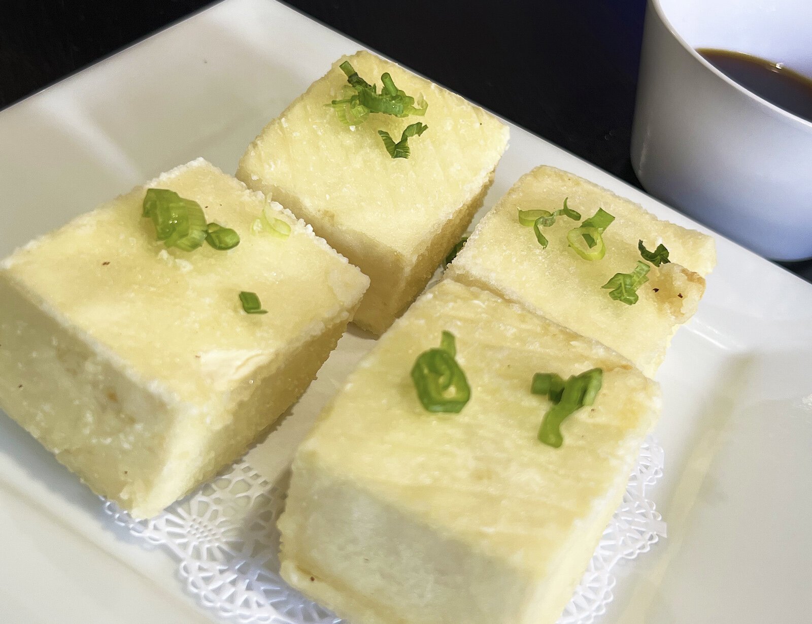The tofu is served in thick squares encased in a fried, but delicate outer ridge.