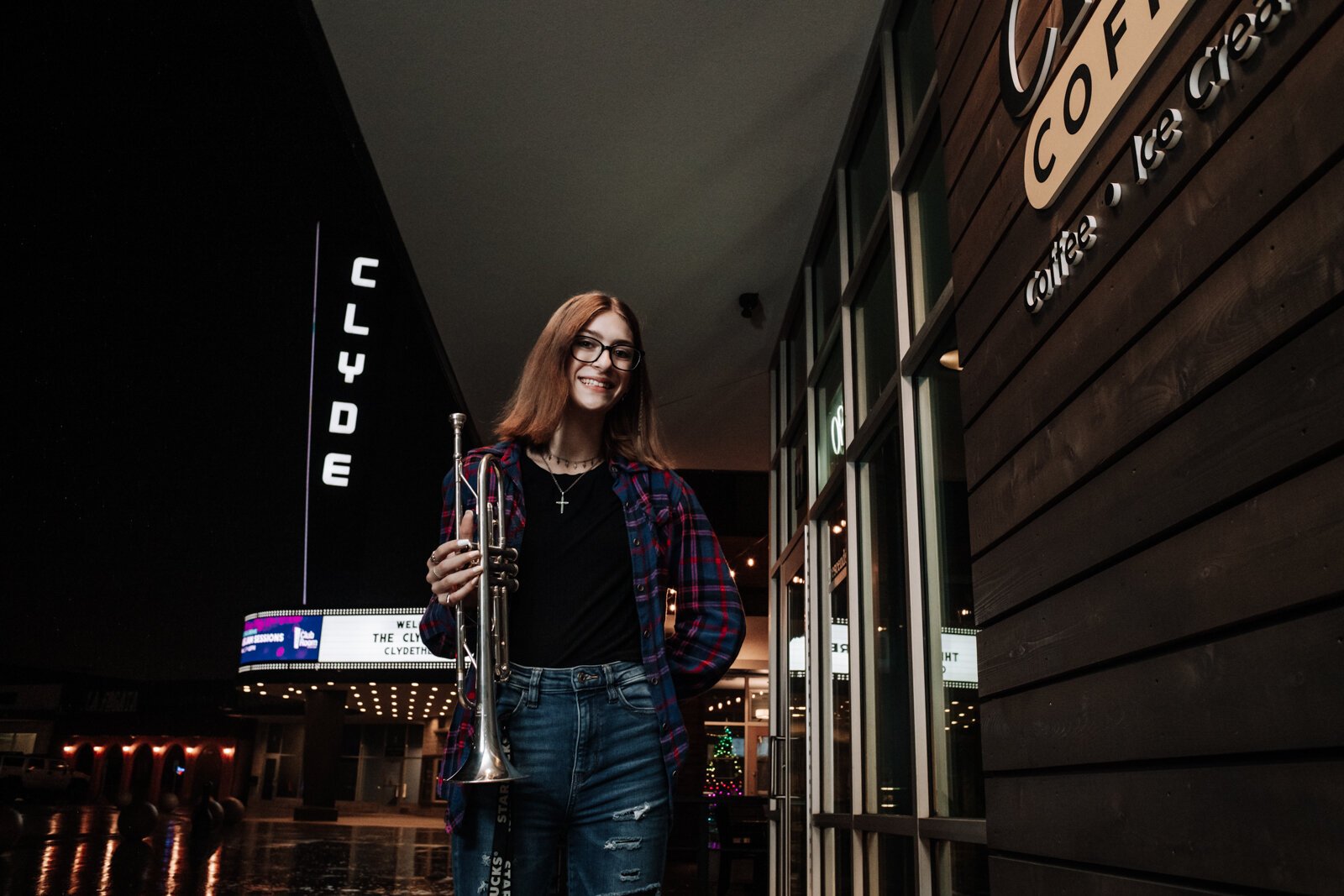 Amara Marion, an eighth grader at Memorial Park, poses with her trumpet at a hotspot for local music in Fort Wayne, the Clyde Theatre, Club Room, and Crescendo Coffee & More.