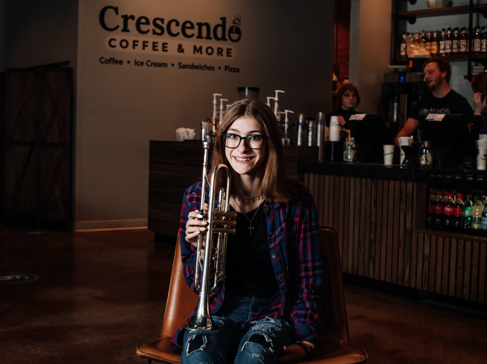 Amara Marion, an eighth grader at Memorial Park, poses with her trumpet at a hotspot for local music in Fort Wayne, Crescendo Coffee & More.
