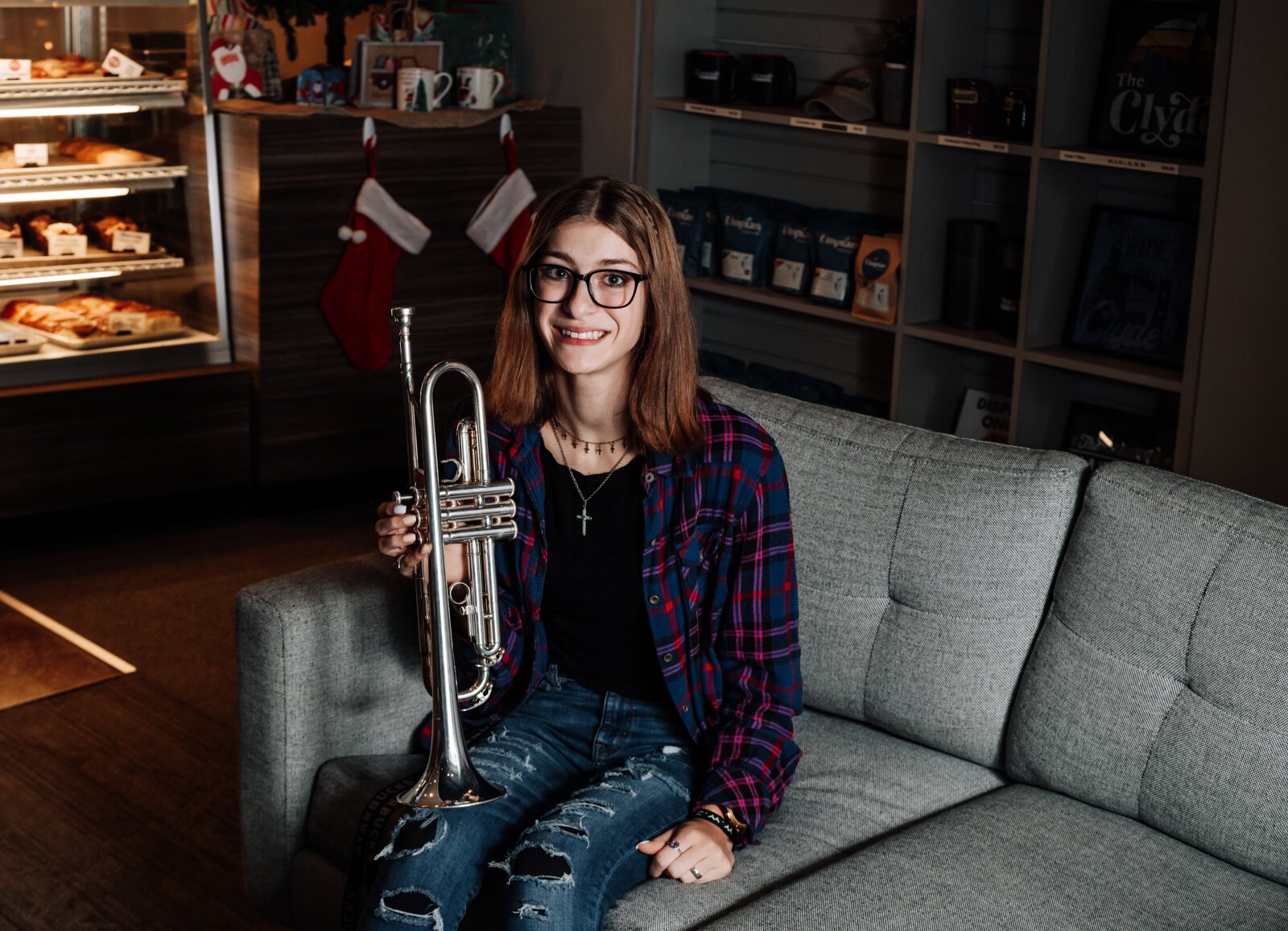 Amara Marion, an eighth grader at Memorial Park, poses with her trumpet at a hotspot for local music in Fort Wayne, Crescendo Coffee & More.