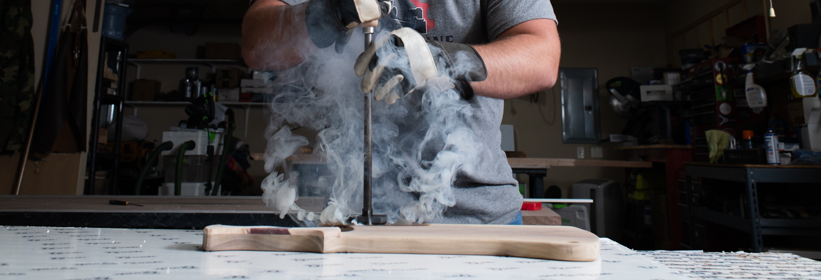 Lee Hoffmeier of Fort Wayne Industrial Revolution brands one of his craft charcuterie boards using a blowtorch.