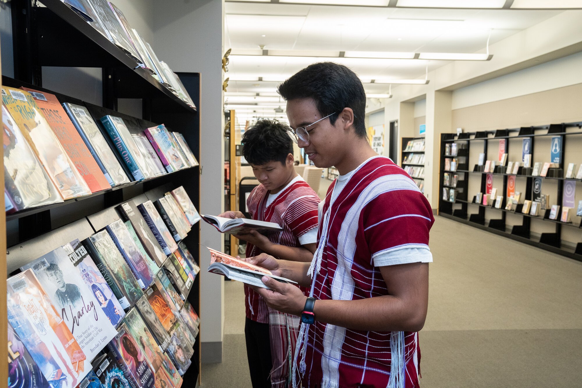 Library patrons explore the New Book Wall at the ACPL.