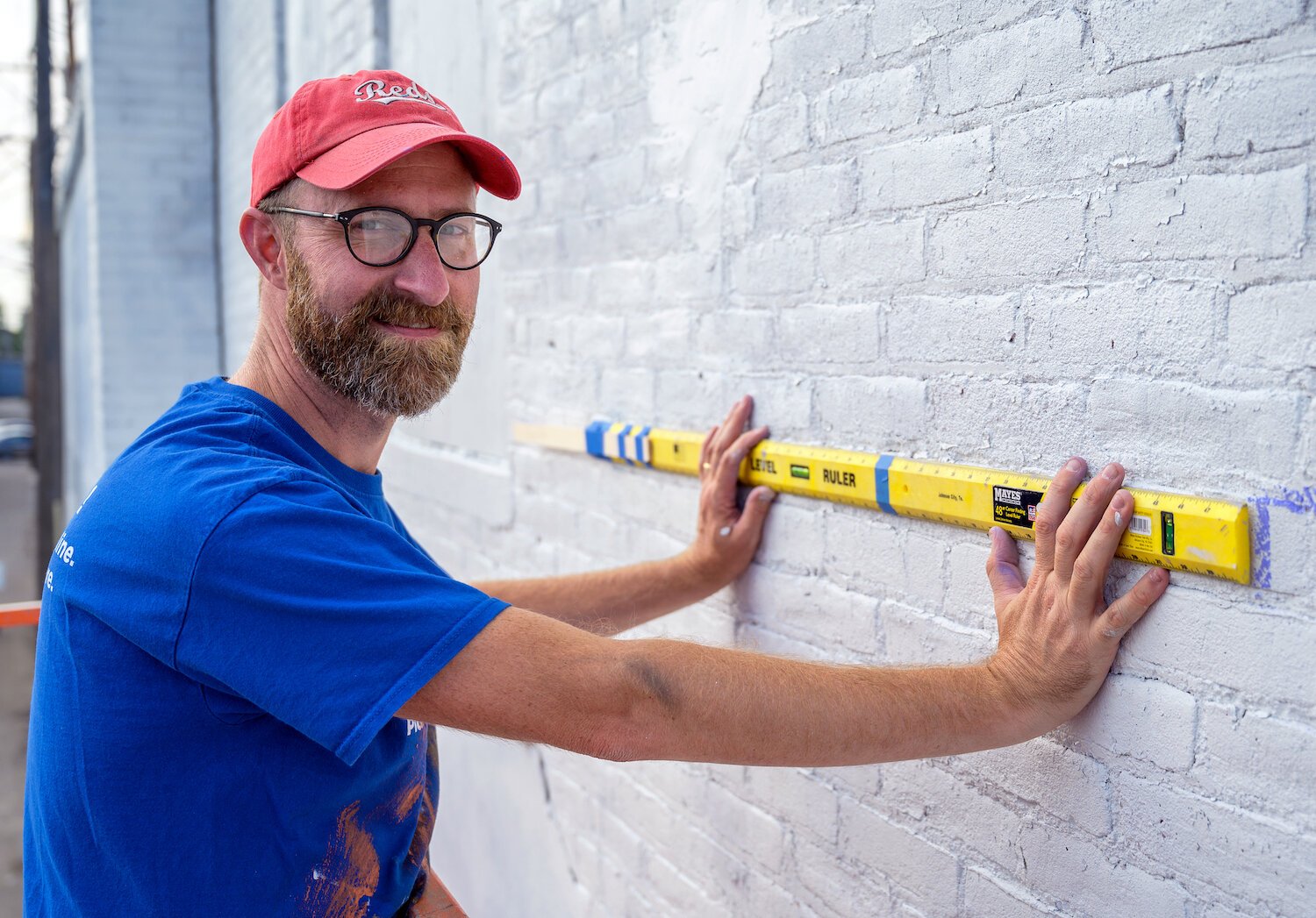 Tim Parsley works on a mural in downtown Warsaw.