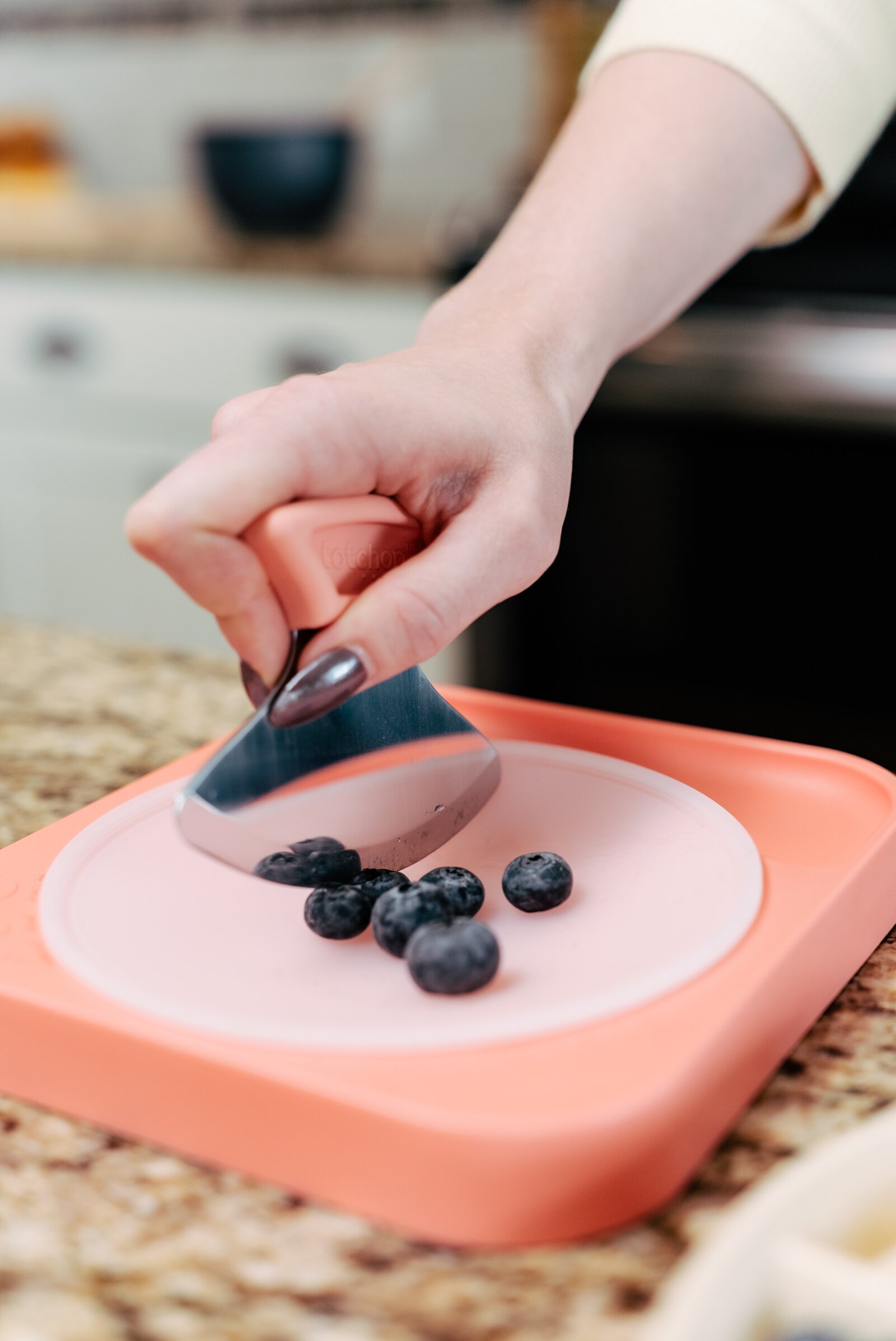 Totchop includes three pieces, a knife, cutting board, and an insert that covers the concave portion of the board.