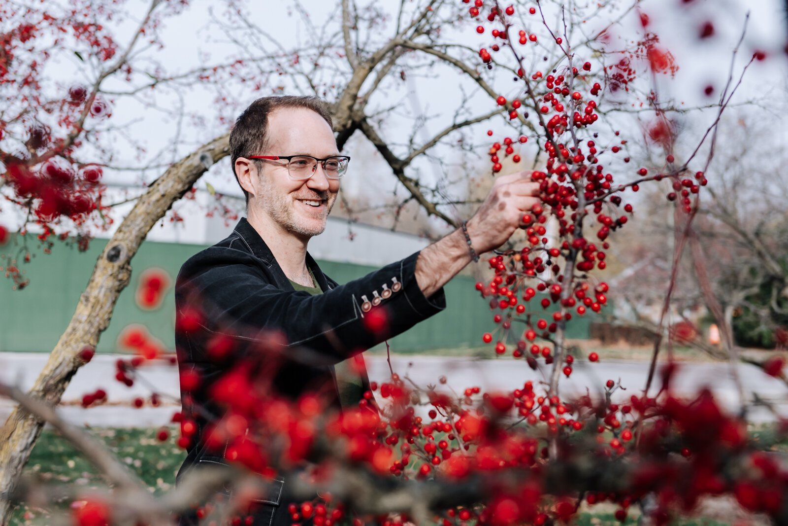 Michael Hoag forages for edible plants and fruit including crab apples at Foster Park in Fort Wayne.