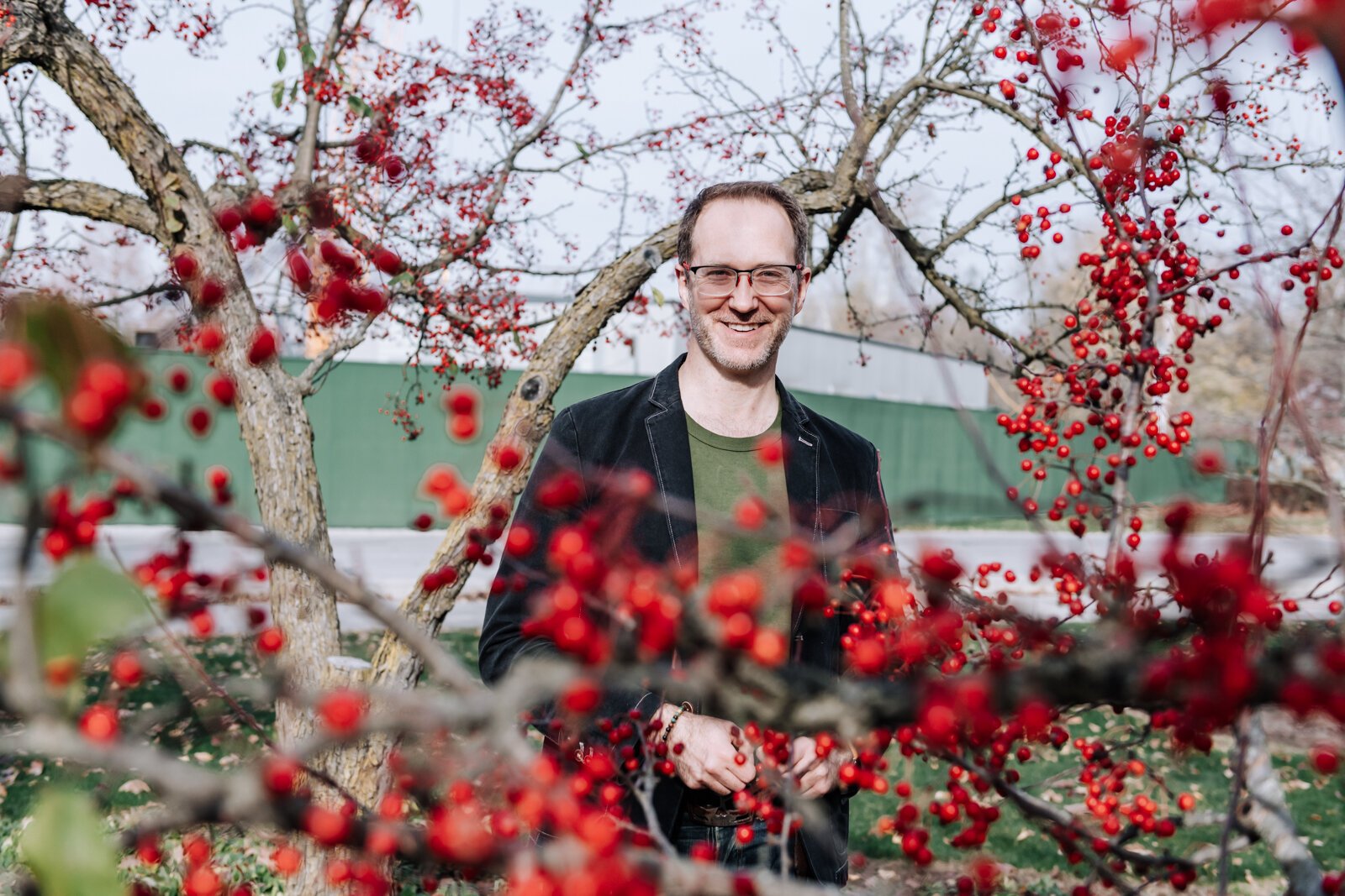 Michael Hoag forages for edible plants and fruit including crab apples at Foster Park in Fort Wayne.