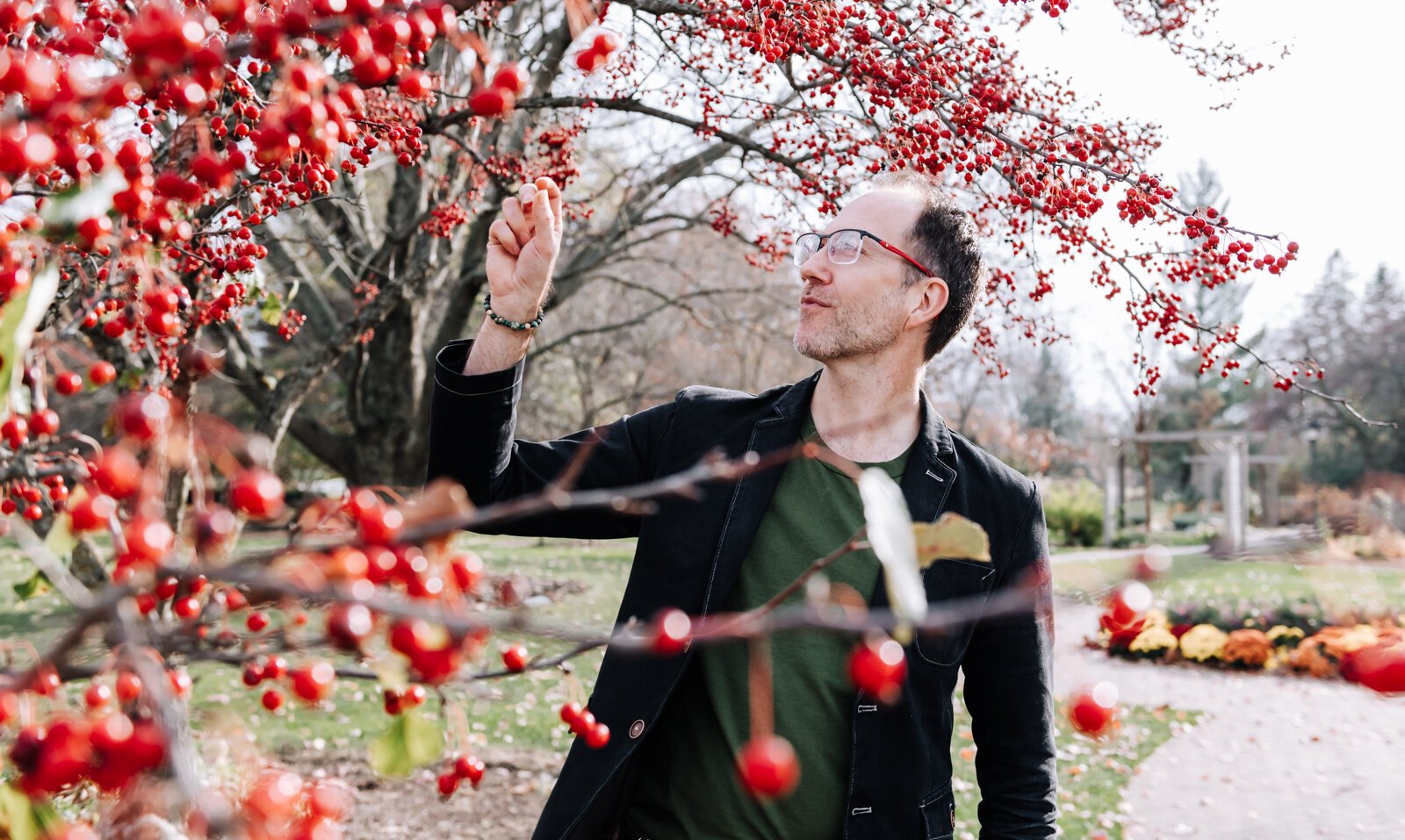 Michael Hoag forages for edible plants and fruit including crab apples at Foster Park in Fort Wayne.