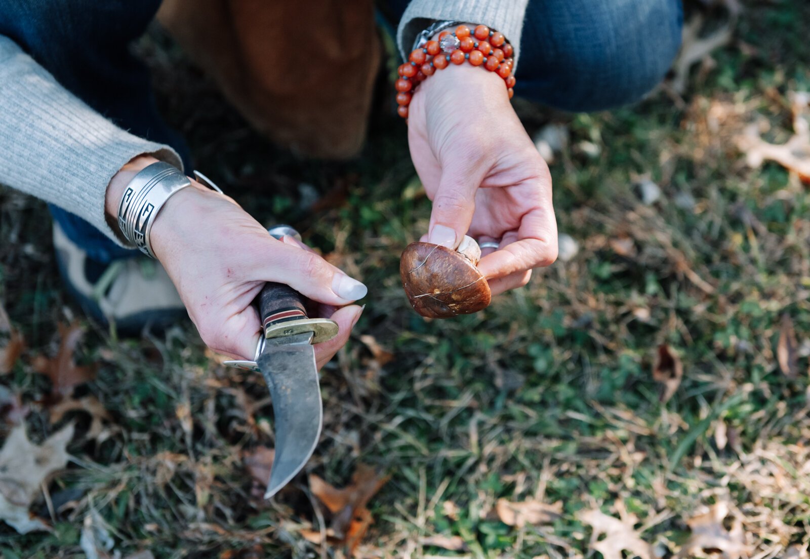 Claudia Hedeen of the Miami Tribe of Oklahoma, forages a mushroom from the genus Suillus with her dog Hobbes on Miami tribal property in Fort Wayne.