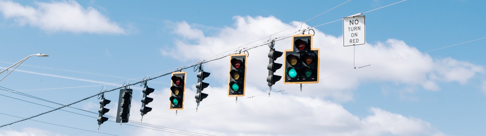 A stoplight at the corner of IN-930 and US-27. We explore the history of Fort Wayne’s roadway system and what can improve it.