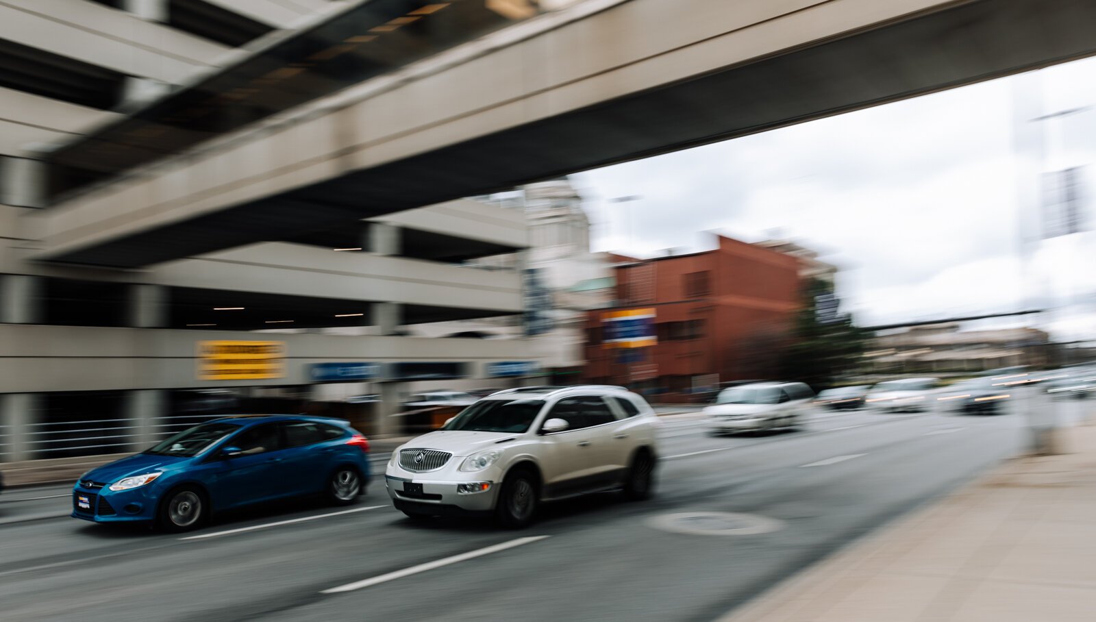 Cars go by on Clinton St. near the intersection of E. Wayne St.