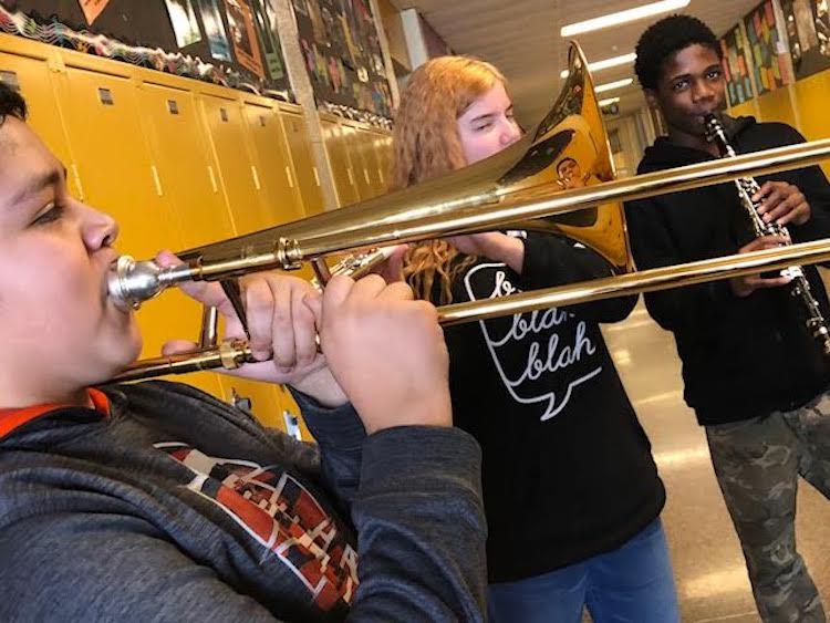 From left, 7th graders Daniel, Bailey, and Jermaine enjoy their instruments.
