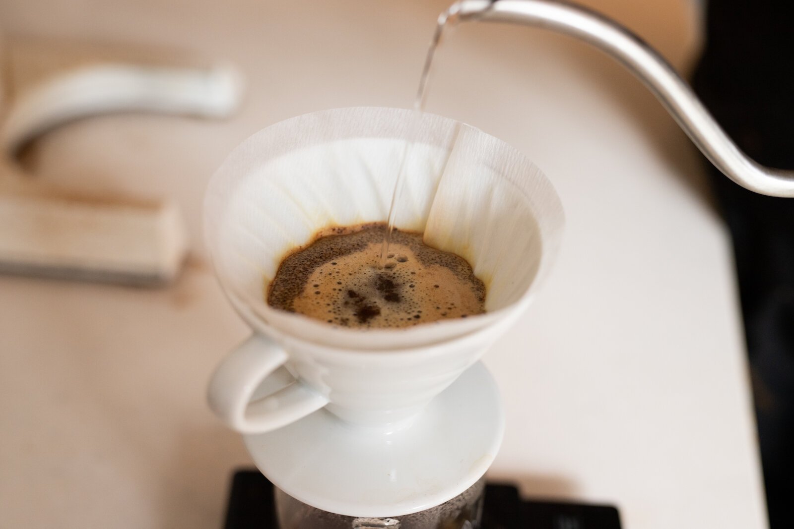 A pour over coffee involves manually pouring hot water through coffee grounds in a filter.