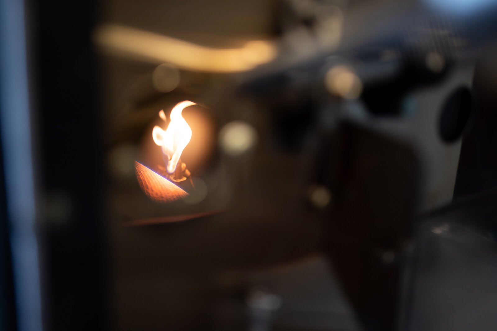 A coffee roaster is a metal drum in a metal casing with a flamethrower underneath and a fan in the back to pull out smoke and air.