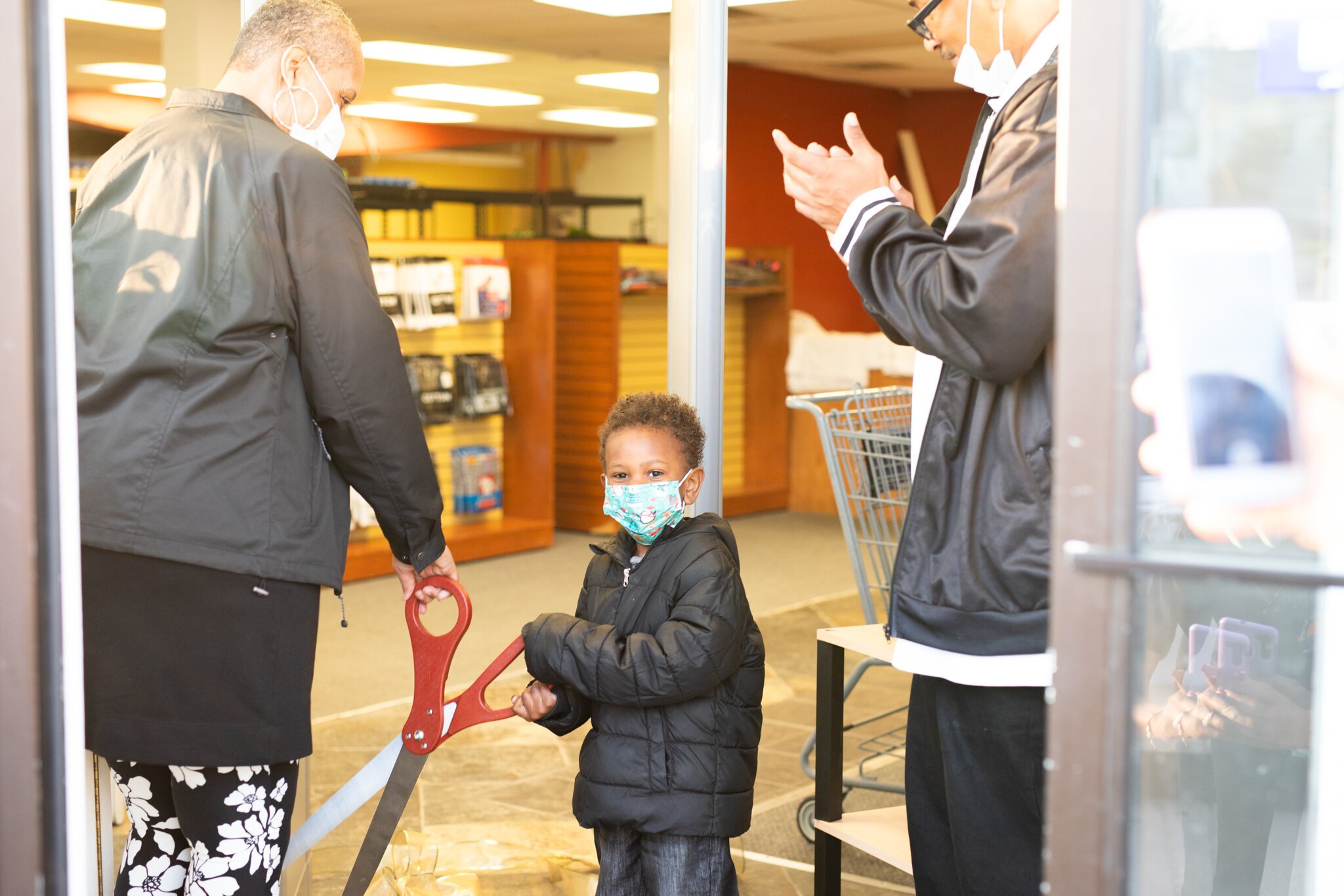 The youngest and oldest members of Ty Simmons’s family were given the honor of cutting the sparking gold ribbon.