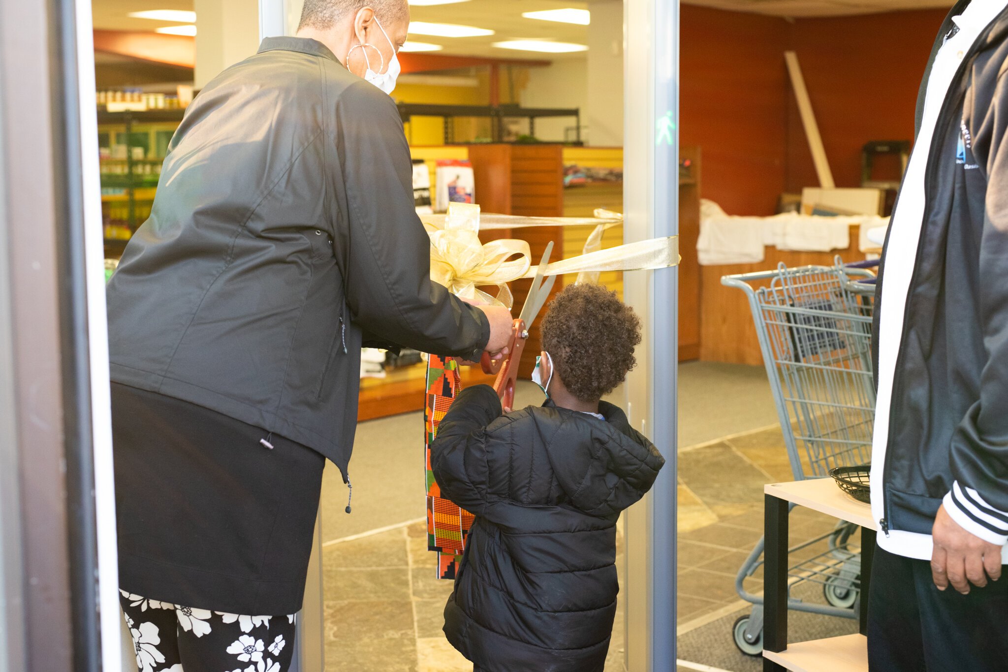 The youngest and oldest members of Ty Simmons’s family were given the honor of cutting the sparking gold ribbon.