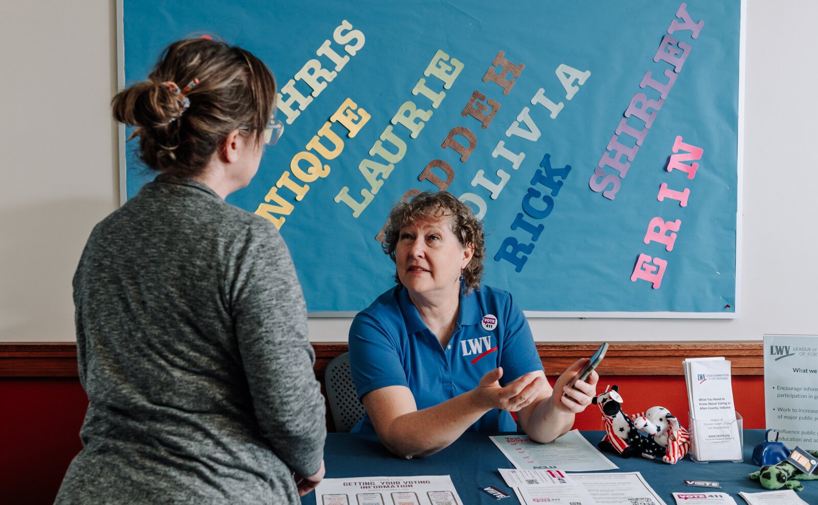 Betsy Kachmar, Co-President of League of Women Voters of Fort Wayne, right,  talks with Chris Castaldi about voting at the Allen County Public Library Tecumseh branch.