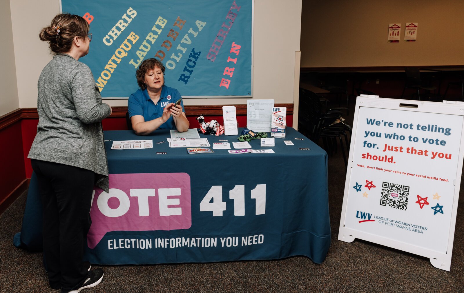 Betsy Kachmar, Co-President of League of Women Voters of Fort Wayne, right,  talks with Chris Castaldi about voting at the Allen County Public Library Tecumseh branch.