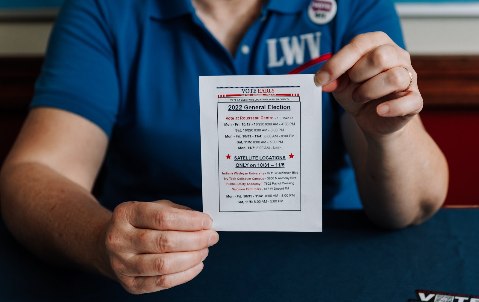 Betsy Kachmar, Co-President of League of Women Voters of Fort Wayne holds up voting information at the Allen County Public Library Tecumseh branch.